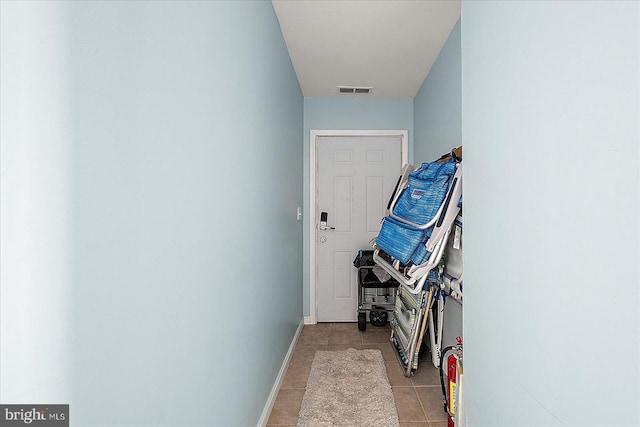 corridor featuring light tile patterned flooring