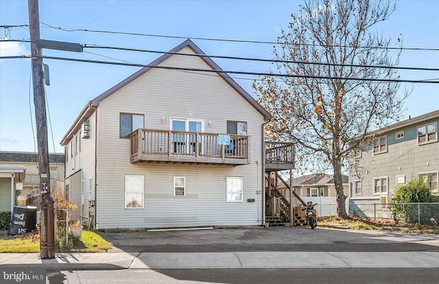 back of property with a balcony