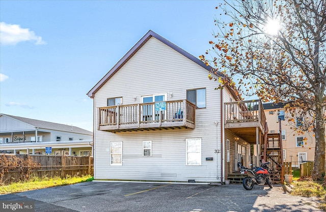 back of property featuring a balcony