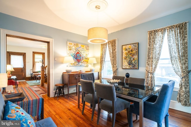 dining space featuring hardwood / wood-style floors and a healthy amount of sunlight