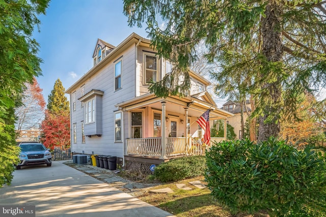 view of front of property with covered porch and central air condition unit