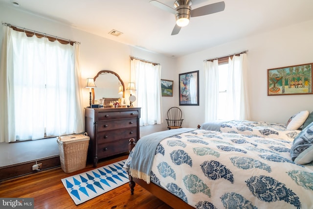 bedroom with ceiling fan and dark hardwood / wood-style flooring