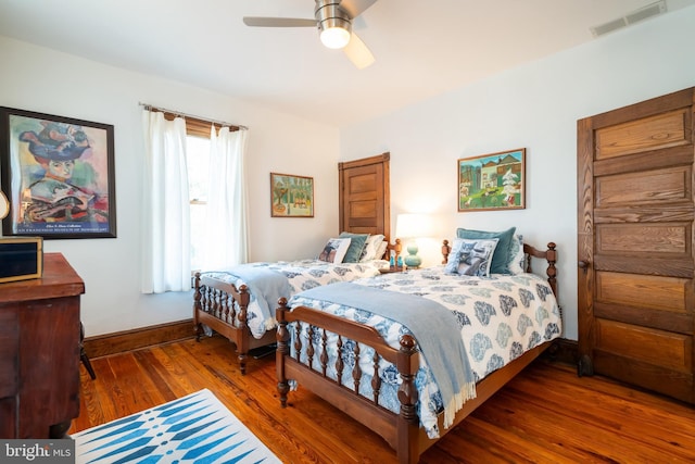 bedroom with ceiling fan and dark hardwood / wood-style flooring