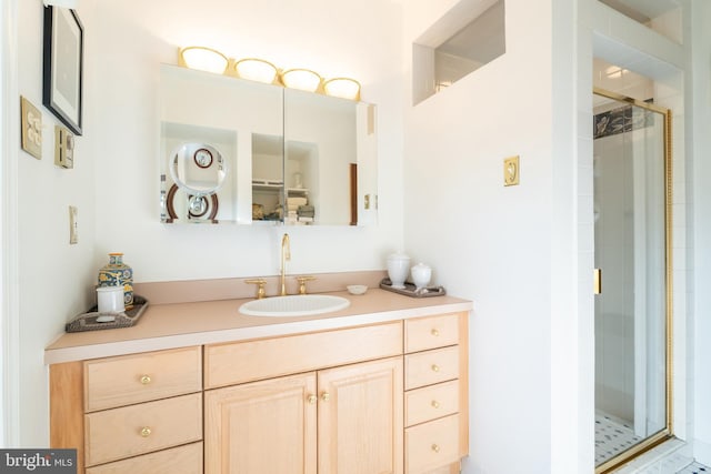 bathroom featuring vanity and an enclosed shower