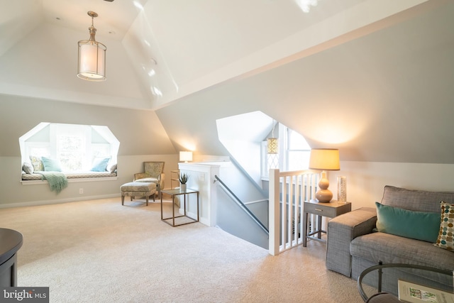 sitting room featuring light colored carpet and vaulted ceiling