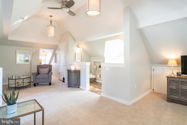 living area with light colored carpet, vaulted ceiling, and ceiling fan