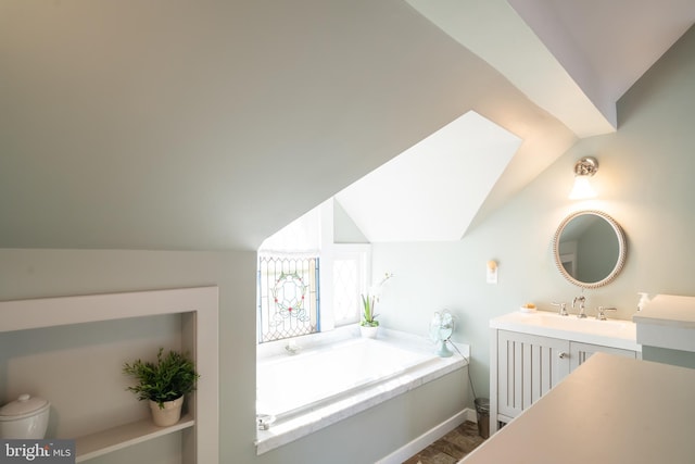 bathroom featuring a bathing tub, vanity, lofted ceiling, and hardwood / wood-style flooring