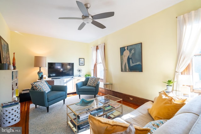 living room with wood-type flooring and ceiling fan