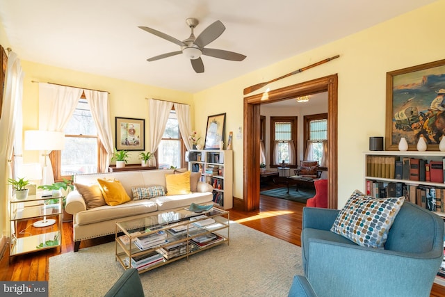 living room featuring hardwood / wood-style flooring and ceiling fan