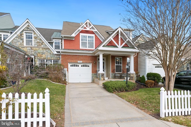 craftsman inspired home featuring a front lawn, covered porch, and a garage