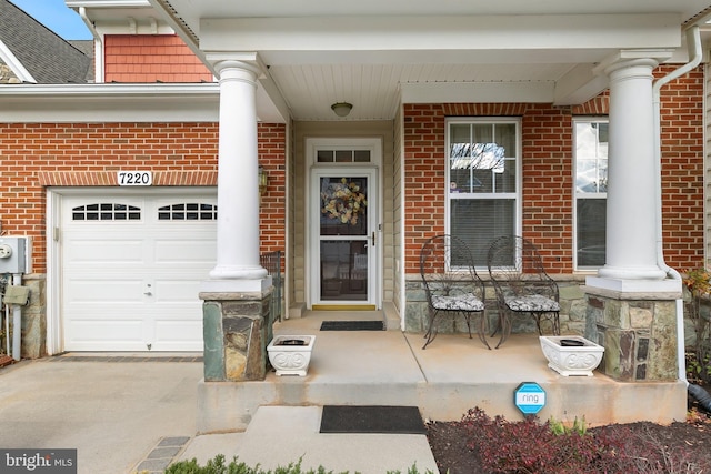 property entrance featuring a garage and covered porch