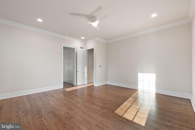 empty room with crown molding, dark hardwood / wood-style flooring, and ceiling fan