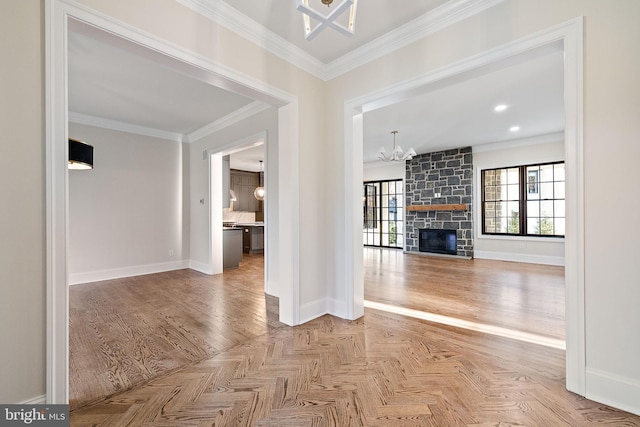 unfurnished living room with a fireplace, an inviting chandelier, parquet floors, and ornamental molding