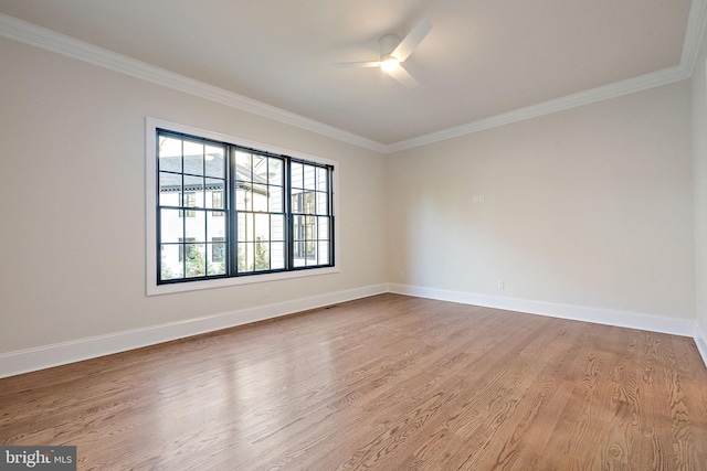 empty room featuring ceiling fan, wood-type flooring, and ornamental molding