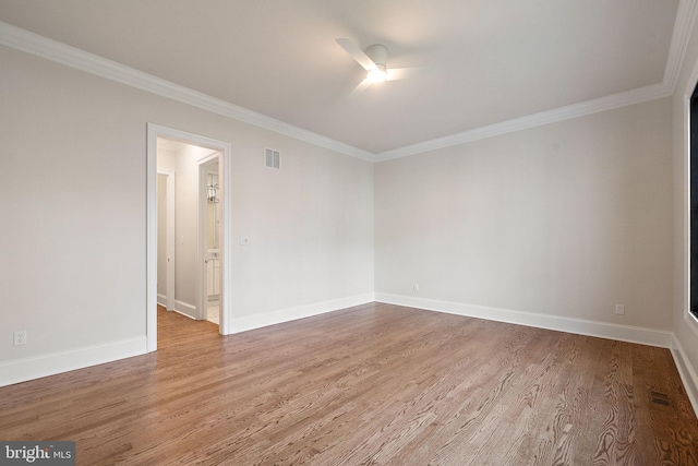 empty room featuring hardwood / wood-style flooring, ceiling fan, and crown molding