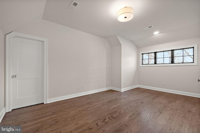 additional living space with dark hardwood / wood-style floors and lofted ceiling