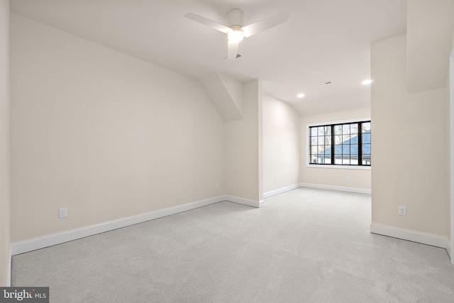 bonus room with ceiling fan, light colored carpet, and vaulted ceiling