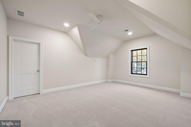 additional living space featuring ceiling fan, light colored carpet, and lofted ceiling