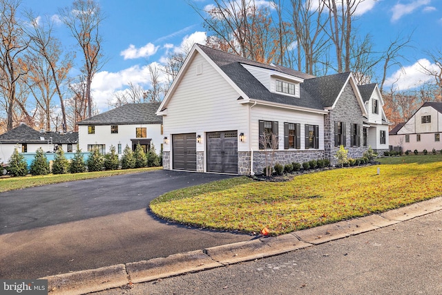 view of front of house with a front lawn and a garage