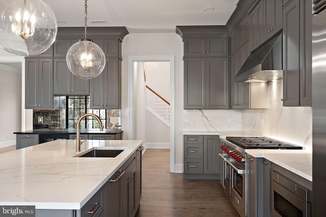 kitchen featuring pendant lighting, stainless steel appliances, gray cabinetry, and sink