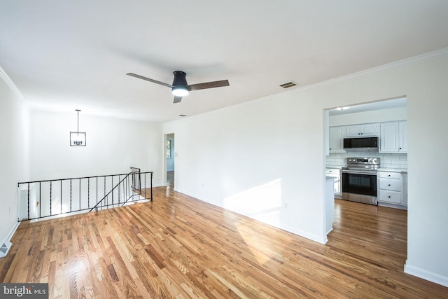 unfurnished room with crown molding, ceiling fan, and hardwood / wood-style flooring