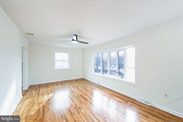 spare room featuring light hardwood / wood-style flooring, ceiling fan, and ornamental molding