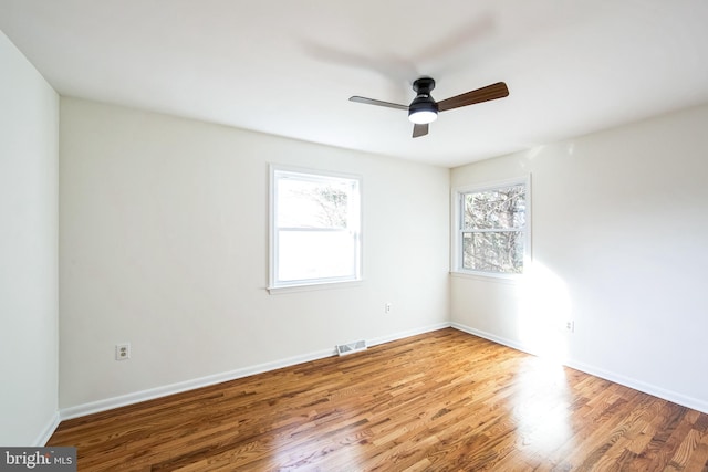 unfurnished room with hardwood / wood-style floors and ceiling fan