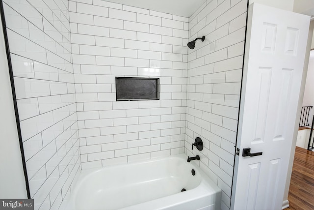 bathroom with wood-type flooring and tiled shower / bath combo