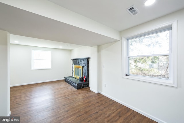 basement featuring dark hardwood / wood-style floors and a fireplace