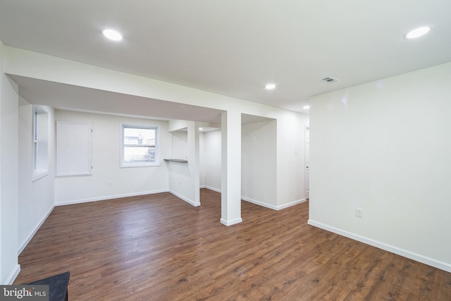 basement with dark hardwood / wood-style flooring