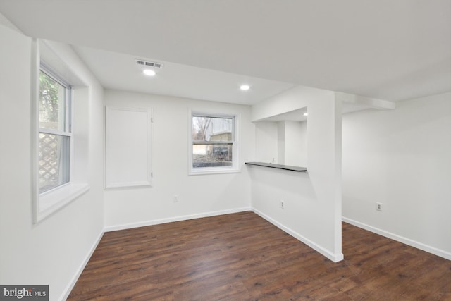 basement featuring dark hardwood / wood-style floors