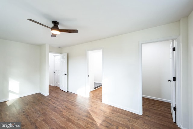 unfurnished room featuring ceiling fan and dark wood-type flooring