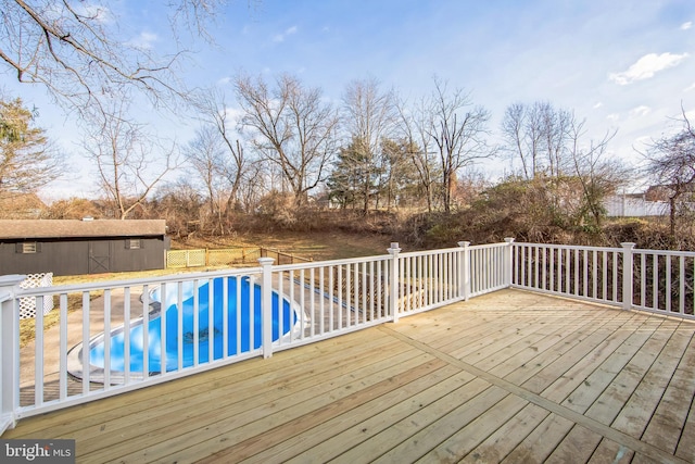 wooden deck featuring a fenced in pool