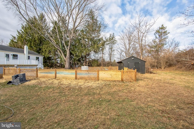 view of yard featuring a shed and a pool