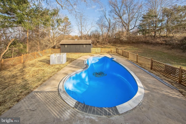 view of pool featuring an outbuilding