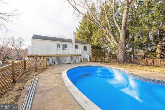 view of swimming pool featuring a deck