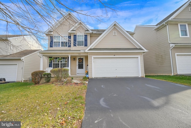 view of front of property featuring a garage and a front yard