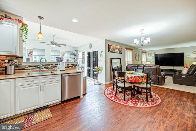 kitchen featuring pendant lighting, sink, stainless steel dishwasher, and ceiling fan with notable chandelier