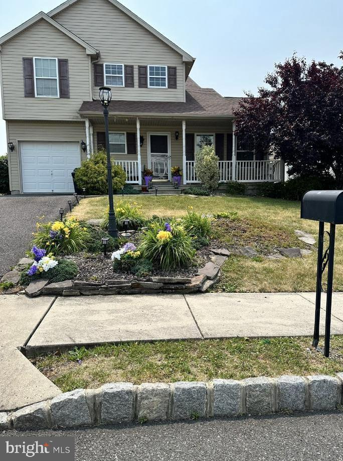 view of front of house with a porch and a garage