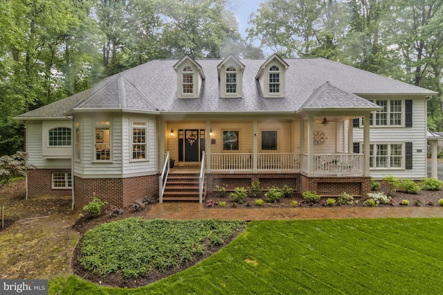 view of front of home featuring covered porch and a front lawn