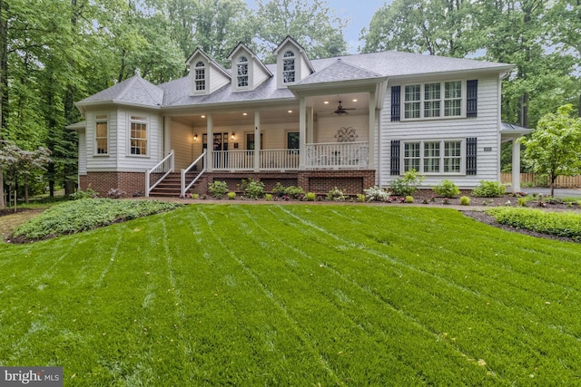 view of front of home with a porch, ceiling fan, and a front lawn