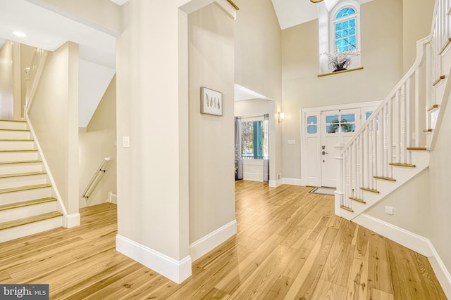 entrance foyer with light hardwood / wood-style floors and a high ceiling