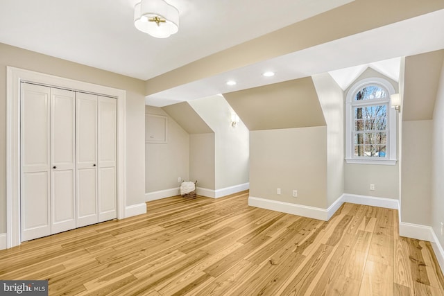 bonus room with light hardwood / wood-style flooring and lofted ceiling