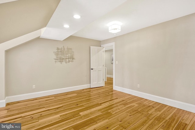 additional living space featuring hardwood / wood-style flooring