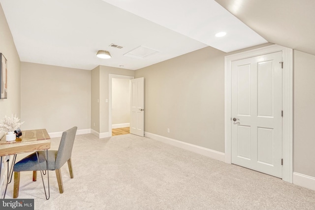 unfurnished office with lofted ceiling and light carpet