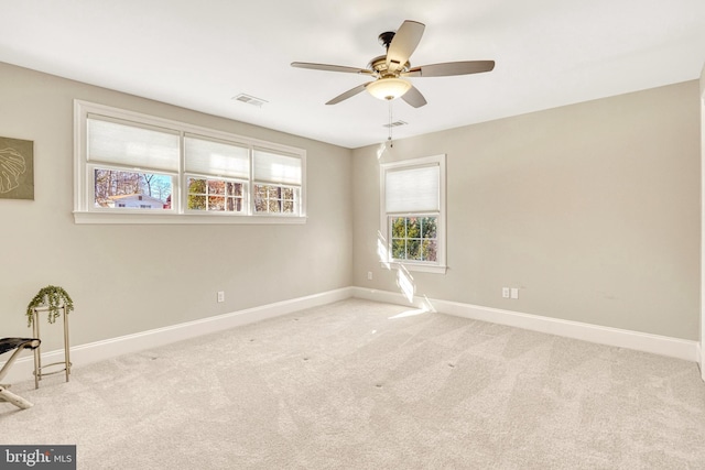 carpeted empty room with ceiling fan