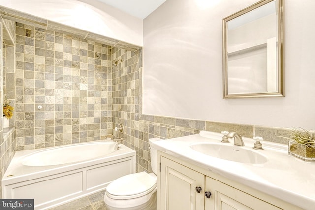 full bathroom featuring tile walls, tiled shower / bath combo, toilet, and vanity