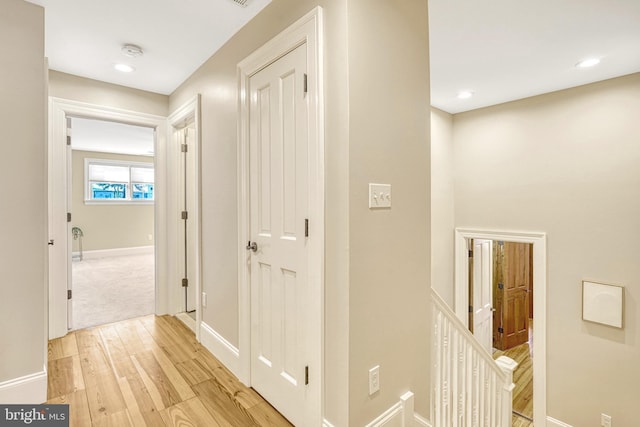 corridor with light wood-type flooring