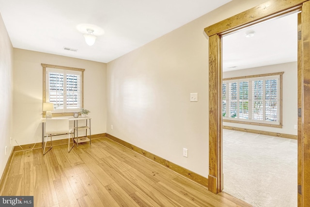 unfurnished room with light wood-type flooring