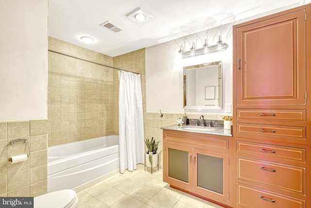 full bathroom with toilet, tile walls, tile patterned floors, shower / tub combo, and vanity